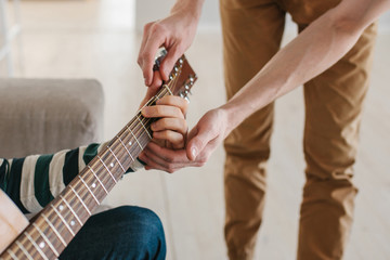 Learning to play the guitar. Music education and extracurricular lessons.