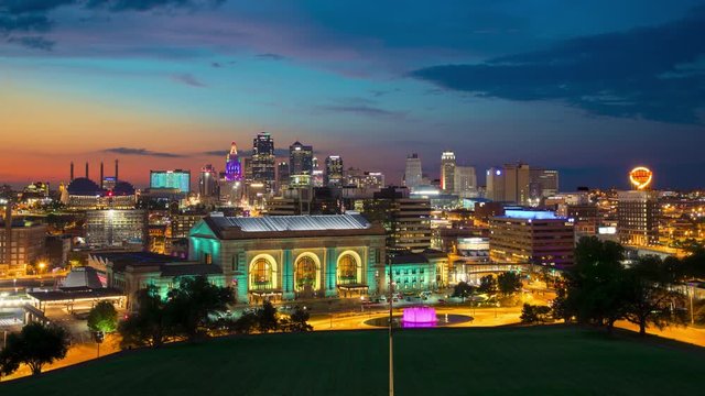 Kansas City Iconic Skyline View in a Vibrant Dusk Setting Overlooking Downtown Skyscrapers with Moving Lights from Buildings and Vehicles under a Colorful Sky