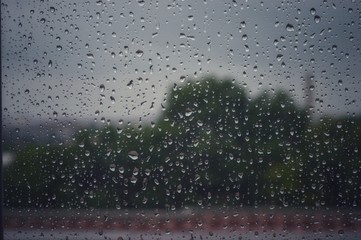 Droplets in the glass of a window during a rain. reflective imagery