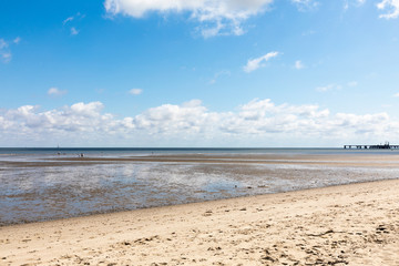 north sea beach with blue sky and clouds