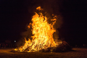 Fire flames with sparks and ember on black background