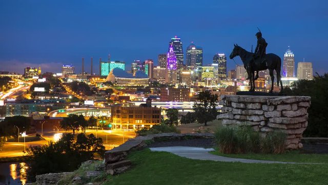 The Scout Statue Overlooking Downtown Kansas City Night Timelpase from Penn Valley Park on a Vibrant Night with Downtown Skyscrapers and Moving Lights