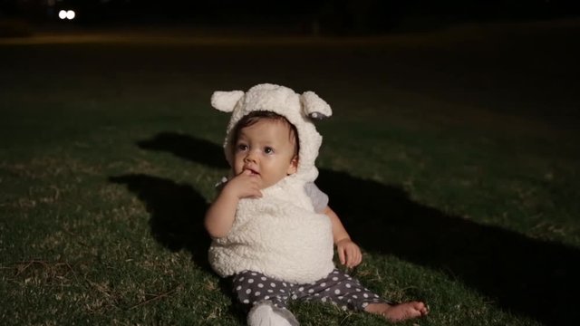 Baby Sitting in Grass Dressed Up as Lamb for Halloween