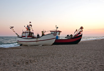 Naklejka na ściany i meble Fishing boat parked on the beach