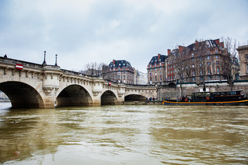 Boat at the Seine river next to the Pont Neuf in a cold winter day in Paris