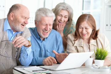 senior couples reading newspaper