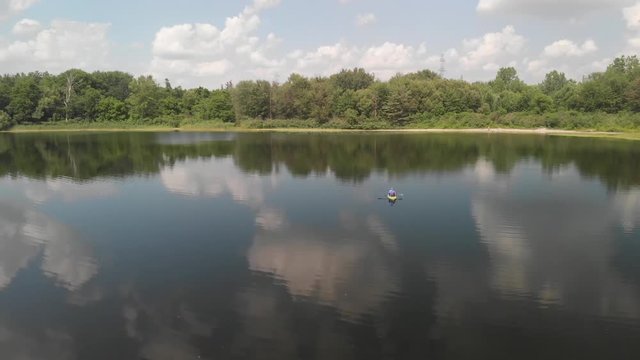 Flying by a kayak on the water.