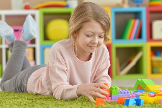 little girl with colorful plastic blocks