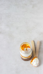 Cheesecake with fruit sauce in a glass jar. No bake cheesecake or trifle. Sweet homemade dessert.