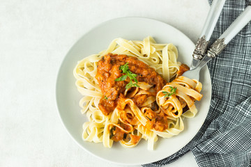 Vegetarian pasta (Tagliatelle) with zucchini, eggplant, bell pepper and tomato sauce.