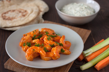 Buffalo shrimp with gorgonzola dip, carrot and celery and pita bread