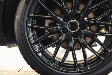 Modern metal rims on car on. Black color. Close up