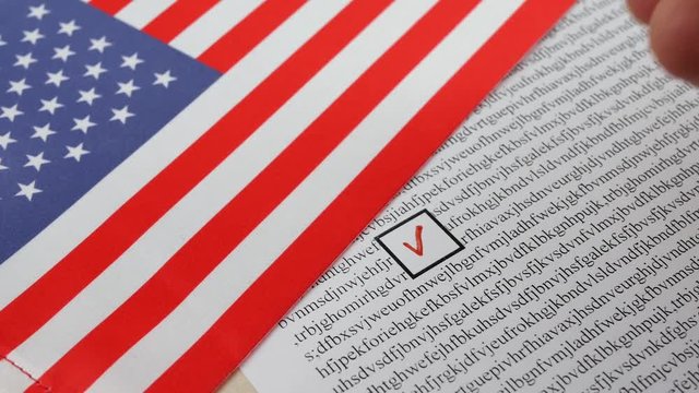 Voting in paper ballot by red pencil in United States of America wirh USA flag