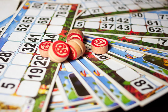 Bingo cards (lotto) and wooden kegs with numbers