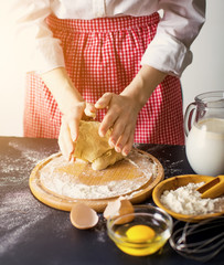 Making dough by female hands at bakery