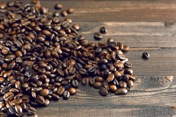 Coffee beans on the wooden background