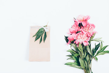 Gift bag decorated with a silver bow and sprig