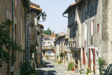 Fototapeta na wymiar Streets and buildings of medieval french old town in summer on a sunny day