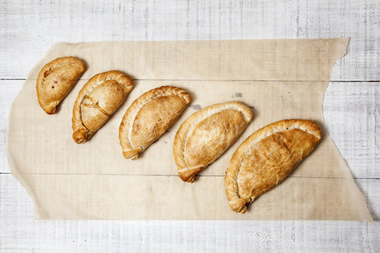 Five Cornish pasty's ranging from cocktail size to large