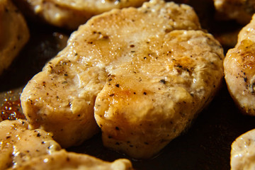 pieces of fried chicken fillet sprinkled with black pepper