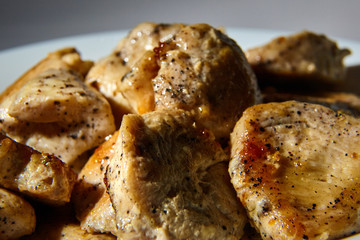 pieces of fried chicken fillet sprinkled with black pepper
