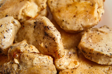 pieces of fried chicken fillet sprinkled with black pepper