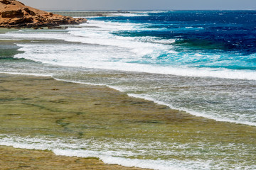 Overlooking the Wide Coral Reef with Large Foamed Waves and Lonely Piers at Calimera Habiba Beach Resort