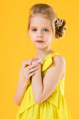 Girl posing on yellow background.