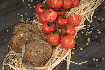 Fresh cherry tomatoes on a wooden table with spices. Top view with a copy.