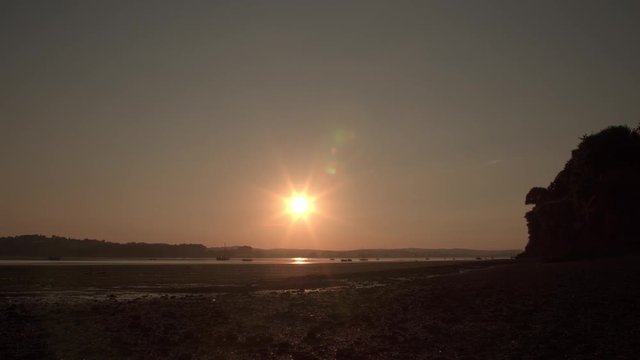 Lympstone estuary sunset time lapse. Clear sky, golden glow. England.