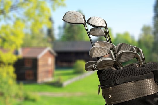 Different golf clubs on natural  background