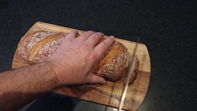 Cutting slices off a bread stick