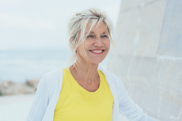 Middle-aged smiling woman with yellow blouse
