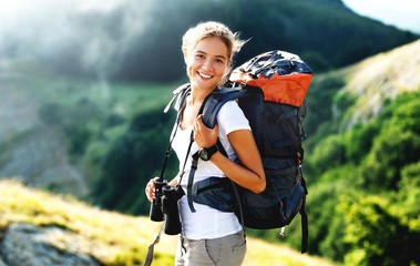 Woman with backpack trekking through the wilderness - Powered by Adobe