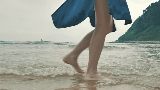 4 k beautifull young girl, mother walking and taking time with her cute little baby, among the Cantabrian coast, in the bay of Atlantic ocean at cloudy morning