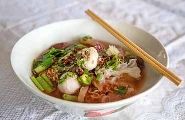 Noodles with seafood soup and red sauce