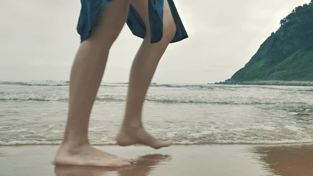 4 k beautifull young girl, mother walking and taking time with her cute little baby, among the Cantabrian coast, in the bay of Atlantic ocean at cloudy morning
