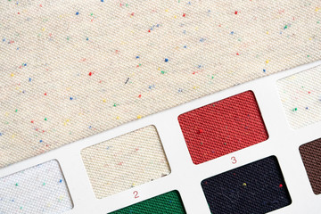 Sketches of clothes and fabric samples for selection. Labe dip beige fabric with red sprinkling.