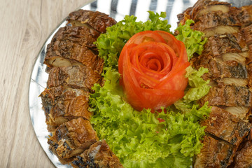 Sliced herring on a plate with herbs.