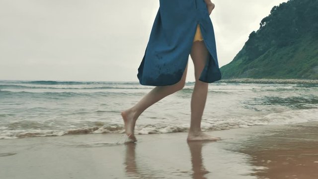 4 k beautifull young girl, mother walking and taking time with her cute little baby, among the Cantabrian coast, in the bay of Atlantic ocean at cloudy morning