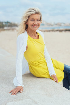Trendy older blond woman at the beach