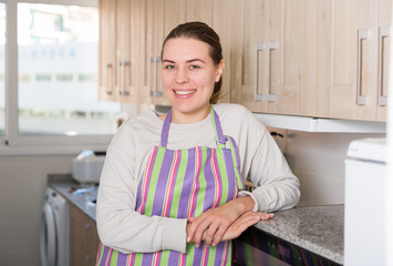 Young woman is posing in the kitchen