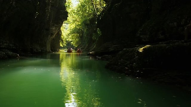People Rafting In Rubber Rowing Boats in Natural Canyon. Beautiful River Among Cliffs 25 fps
