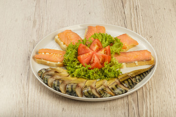 Sliced herring on a plate with herbs.