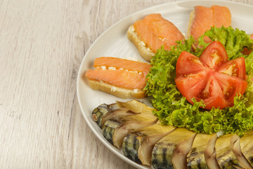 Sliced herring on a plate with herbs.