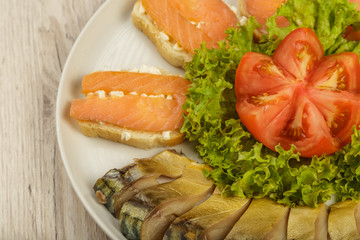Sliced herring on a plate with herbs.