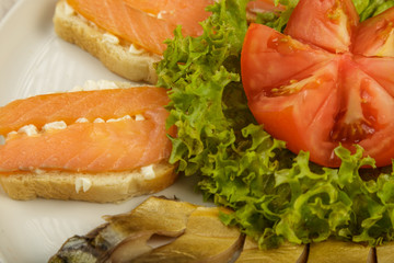 Sliced herring on a plate with herbs.