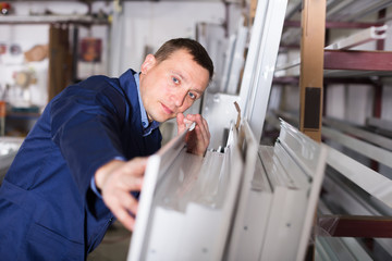 Smiling workman inspecting PVC manufacturing