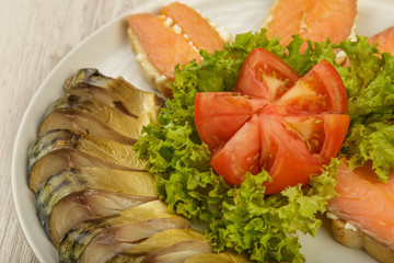 Sliced herring on a plate with herbs.