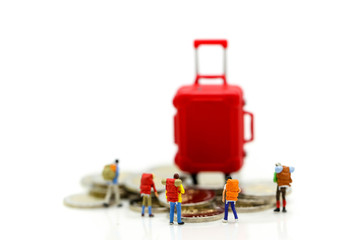 Miniature concept : Group of young traveler traveling / standing on coin Currency of the world,business trip traveler concept.
